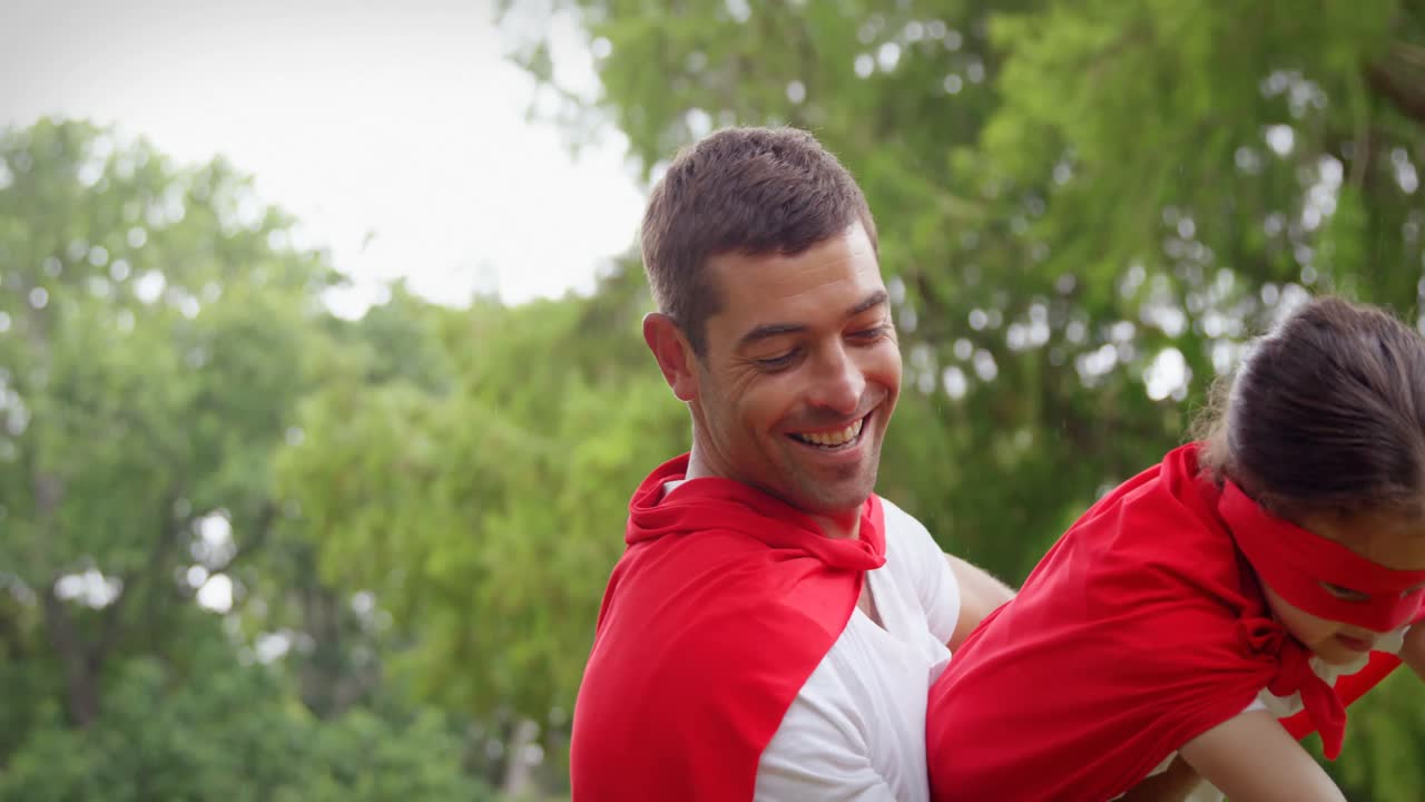 chica enmascarada y padre fingiendo ser un superhéroe