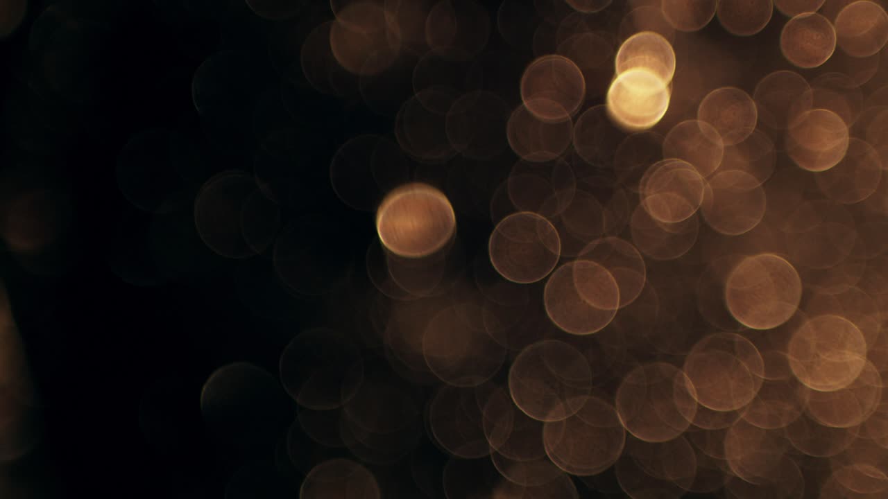 Luci Bokeh Dorate Calde su Sfondo Scuro