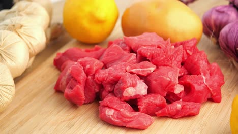 raw beef cubes with ingredients for cooking