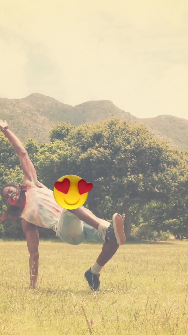 Animation of emoticons floating over man dancing outdoors
