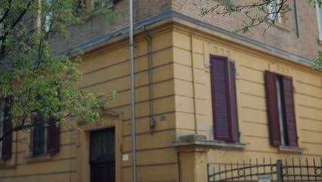 italian building with trees and brown shutters