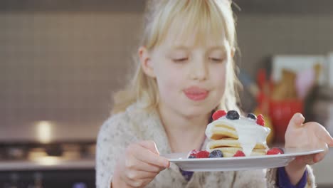 girl holding plate of pancake 4k