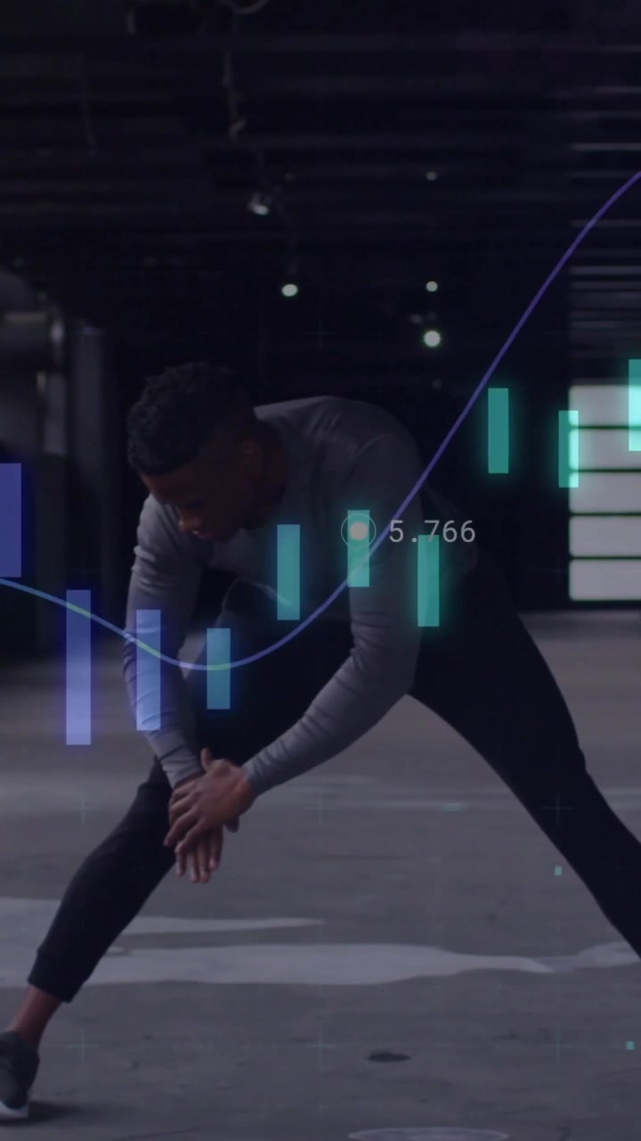 Vertical video: Man starting stretch in garage, reaching ankle while data bars wave syncing health