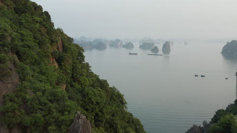 Aerial-over-tall-limestone-islands-in-Ha-Long-Bay,-Vietnam