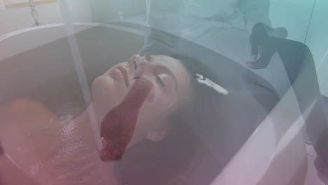 relaxing in bathtub, woman with serene expression enjoying gentle lighting ambiance