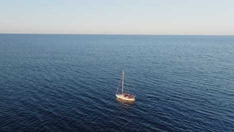 a cinematic aerial view of a boat in the north of menorca, spain