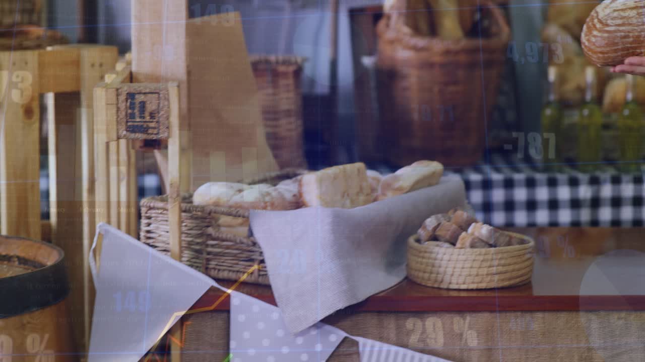 Female baker bringing loaf into shot, showing product while animated bakery charts rising on glass