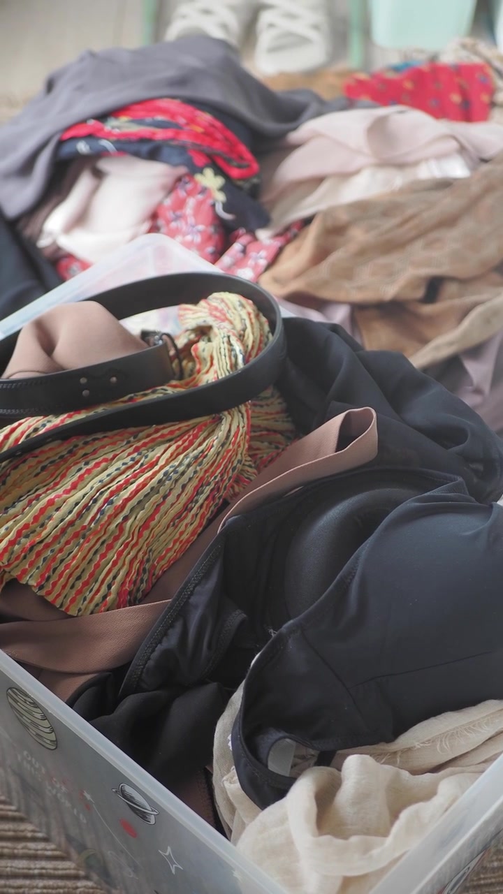 Clothes and Accessories Stored in a Clear Plastic Box