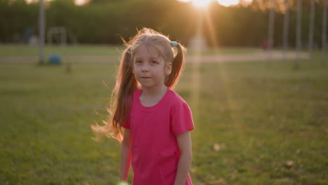 girl with wounded eye shakes hair and looks in camera