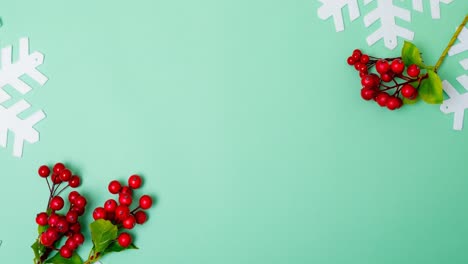 animation of christmas decorations, snowflakes and copy space on green background