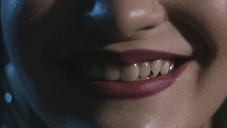 close-up of a woman's smiling mouth with red lipstick