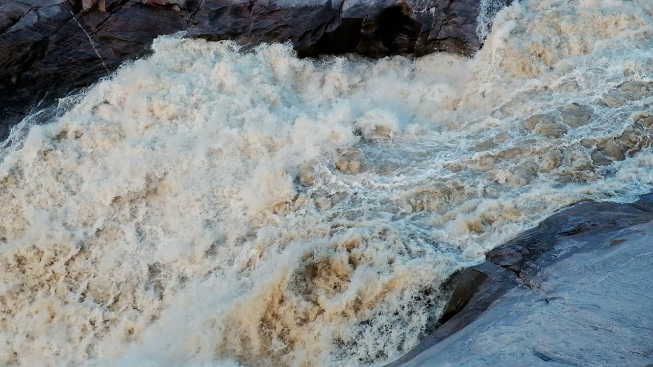 Huge amounts of water flowing over the Augrabis waterfall in South Africa on the Orange River