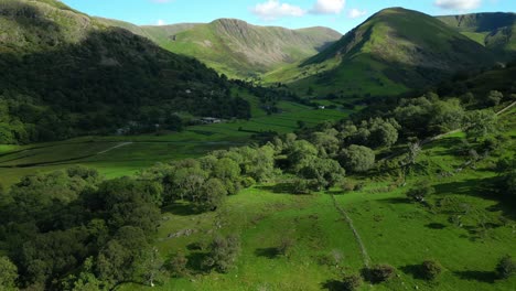 Lush-green-wooded-hills-and-mountains-with-cloud-shadows-on-summer-day