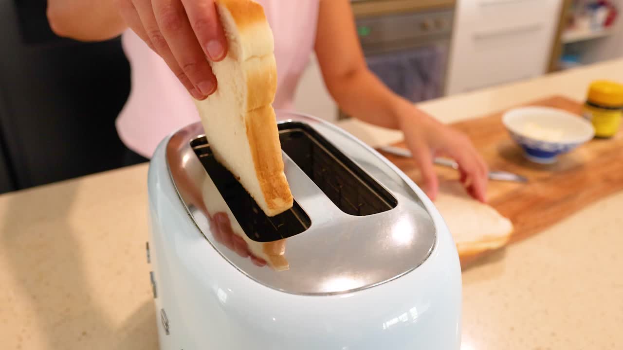 Woman toasting bread in the kitchen