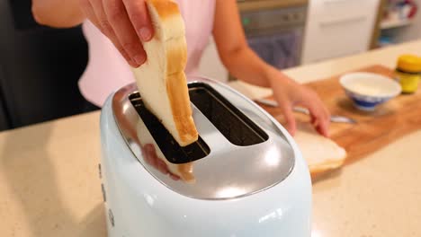 woman toasting bread in the kitchen