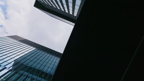 spinning ground view of generic skyscrapers and cloudy sky, no people