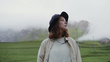 woman in a hat in the mountains