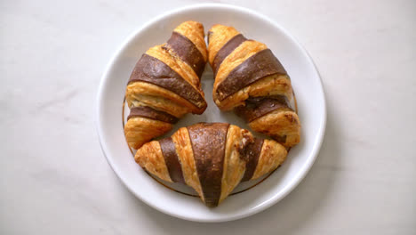 fresh-croissant-with-chocolate-on-plate