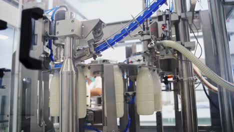 production line at modernized dairy factory. automated production line at milk factory. milk pouring into plastic bottle at dairy plant.