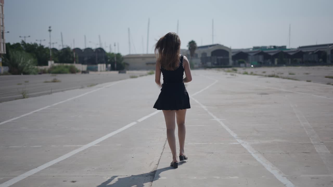 Woman Walking in an Empty Parking Lot