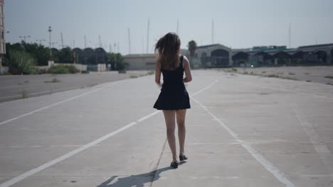 woman walking in an empty parking lot
