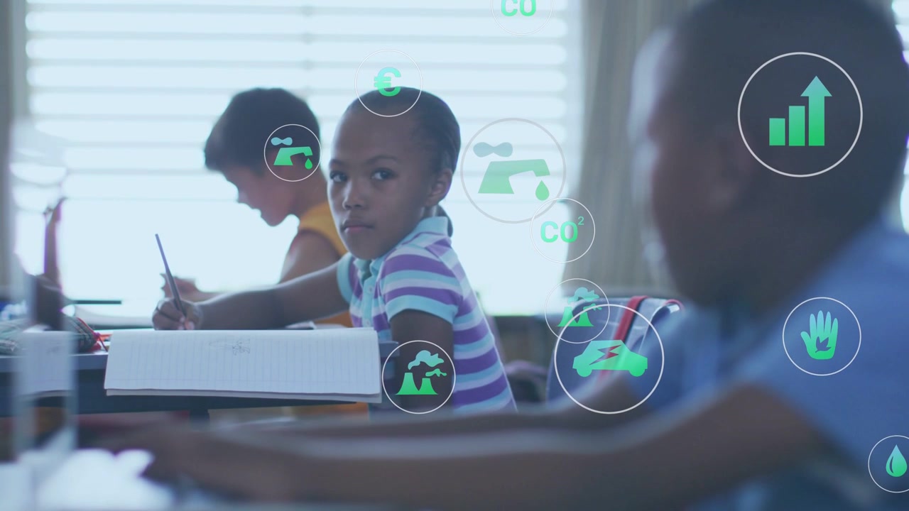 Boy in blue shirt typing computer, causing eco icons moving across class, centering girl for lesson