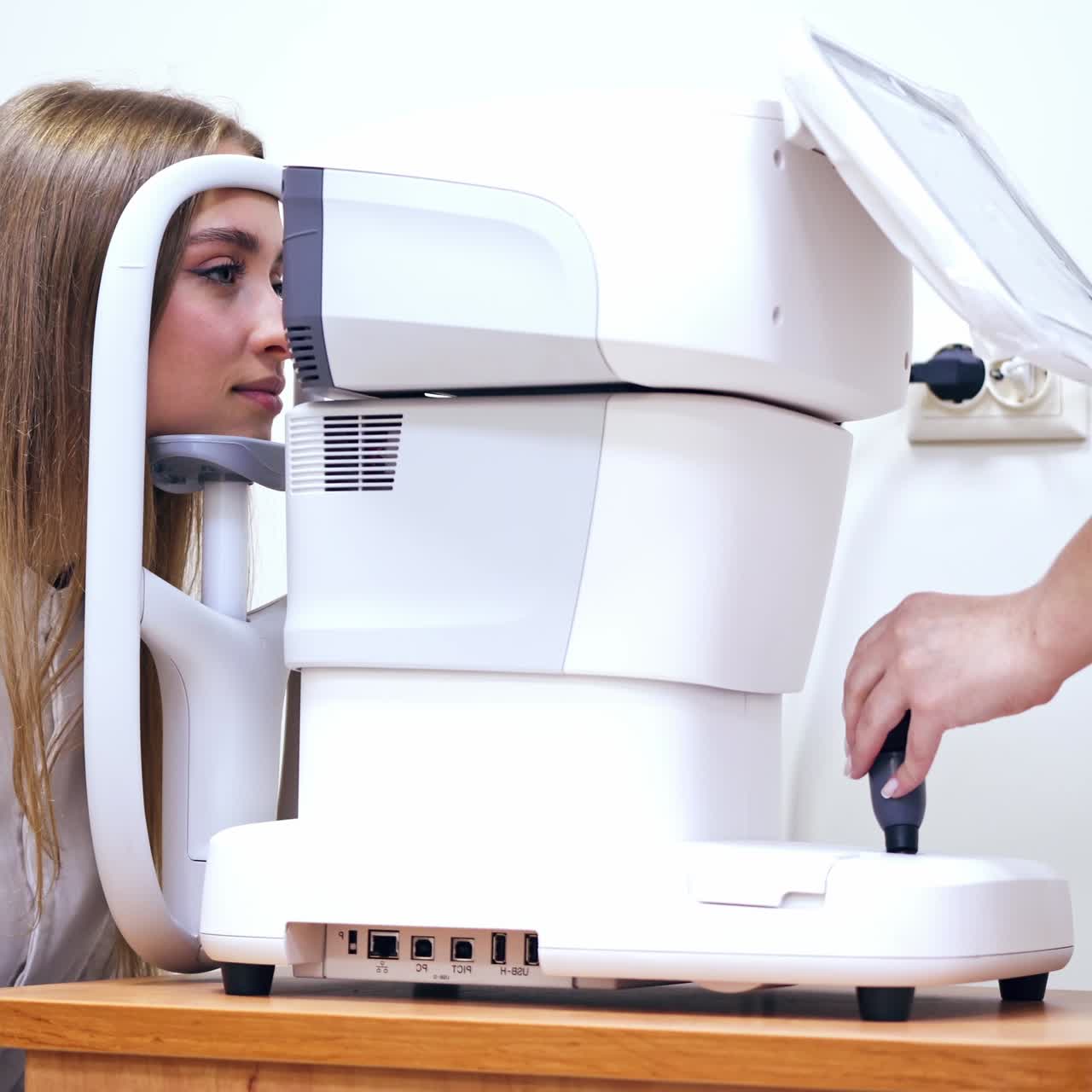 Woman checking eye in clinic