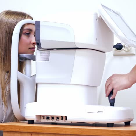 woman checking eye in clinic