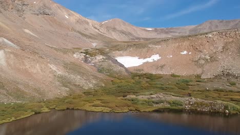 Aerial-views-of-Mosquito-Pass-in-Colorado-showing-fall-colors-on-large-meadows-with-touches-of-water-and-snow