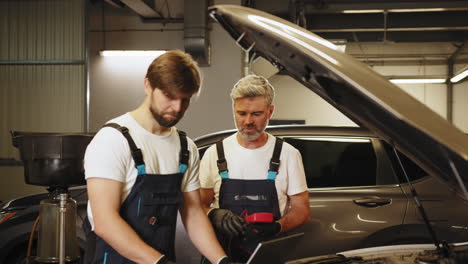 car repair and maintenance by mechanics in a garage