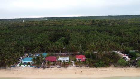 Pull-back-shot-of-a-popular-beach-in-the-town-of-Bolinao,-Pangasinan,-Philippines