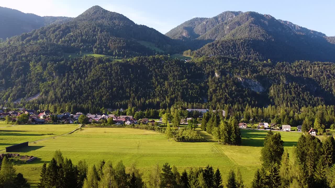 drone view of the sun setting over Gpzd Martuljek village in Slovenia
