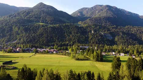 drone view of the sun setting over gpzd martuljek village in slovenia