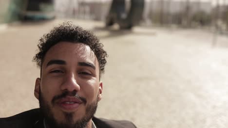 handsome young middle eastern man talking to camera