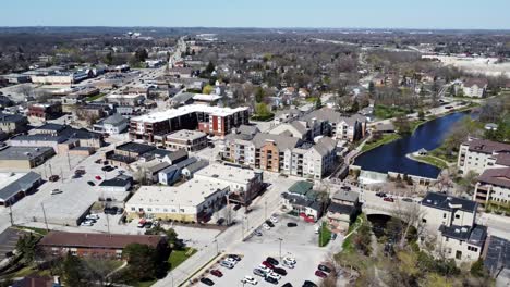 aerial-flyover-of-a-small-downtown-tourist-town-with-waterfall