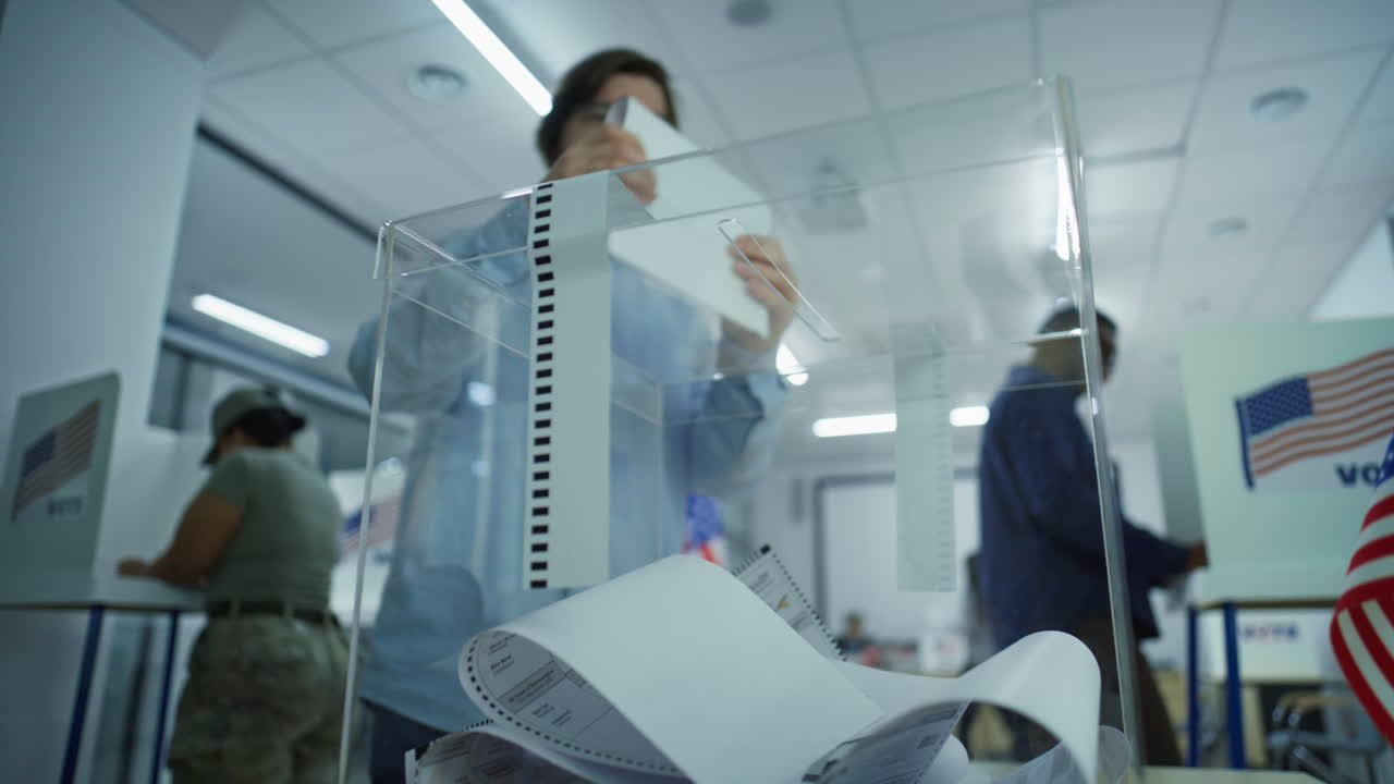 Caucasian Male Voter Puts Ballot Paper in Box at Polling Station Caucasian Male Voter Puts Ballot Paper in Box Multicultural People us Citizens Vote in Voting Booths at Polling Station National Election Day in the United States of America Civic Duty Concept