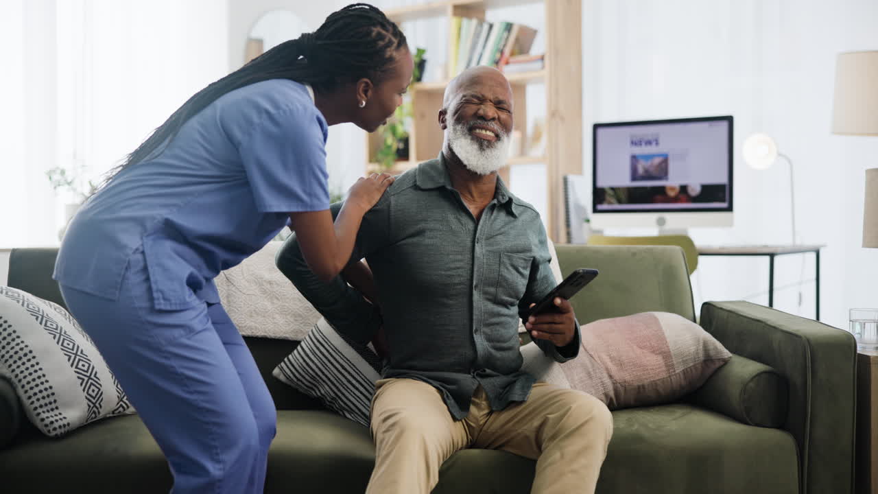 Nurse Assisting Elderly Patient with Back Pain at Home