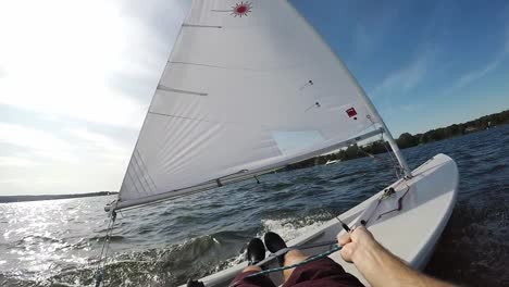 pov shot of sailing a laser sail boat on lake wannsee in berlin germany, gusty wind, slow motion