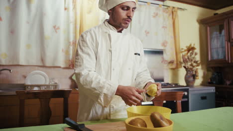 private home chef peels italian potatoes on the table