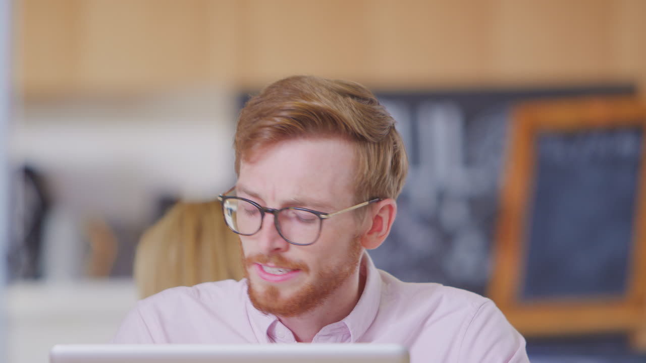 Businessman Working On Laptop In Office Coffee Shop