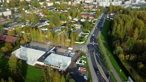 aerial orbit over a small tank next to a bicycle path and a main road in the city of järvenpää, southern finland