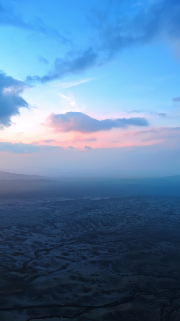 Barren rocky landscape of a stunning Iceland. Aerial perspective on the scenery covered with haze. Vertical video.