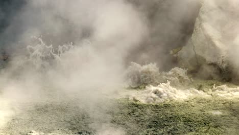 toxic geothermal sulfur mud pool boiling water and emitting steam