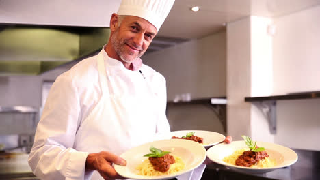 Chef-showing-pasta-dish-with-basil-leaf