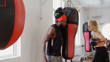 female boxer practicing boxing in fitness studio 4k