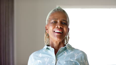 african american senior woman standing indoors, smiling at camera