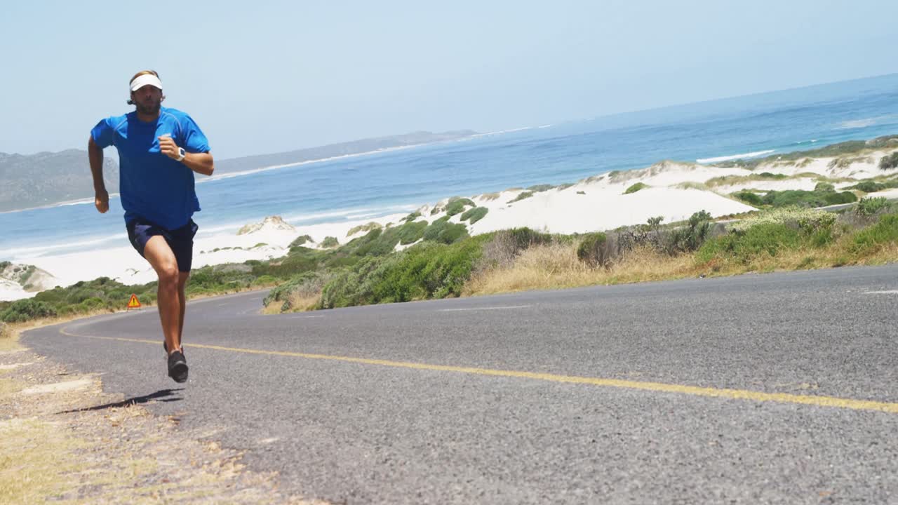 Triathlete man jogging in the countryside road