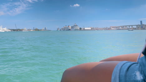 Woman-sitting-on-wall-watching-the-ocean