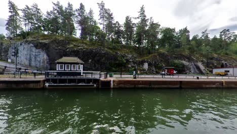 motion lapse of white yachts sailing through lock gates, sweden