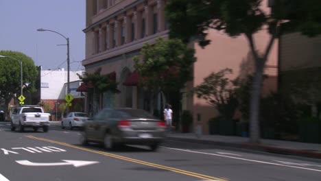 a car travels along a street in santa monica california as seen through the rear window at an angle 1